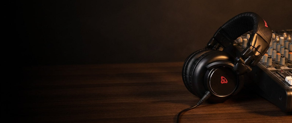 Cerwin Vega HB Series headphones on a studio desk beside a mixing console